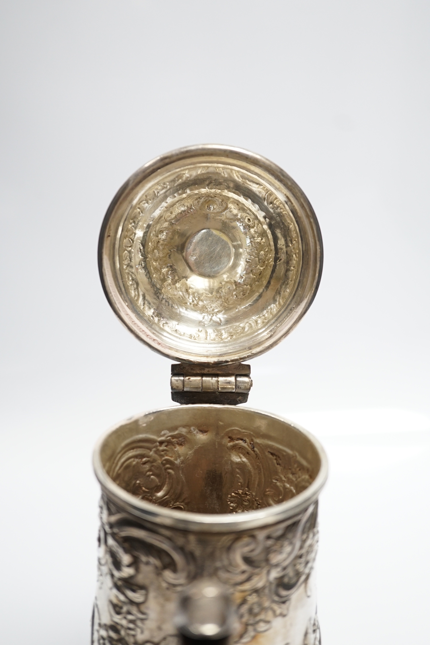 A George II silver baluster coffee pot, with later embossed decoration, maker, ?W, London, 1751, height 25.5cm, gross weight 31.3oz.